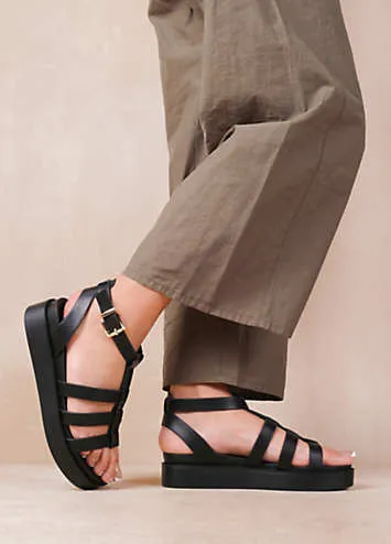 Where’s That From Dubai Extra Wide Fit Mid Platform Gladiator Strap Sandals in Black PU Look Again