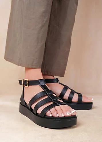 Where’s That From Dubai Extra Wide Fit Mid Platform Gladiator Strap Sandals in Black PU Look Again